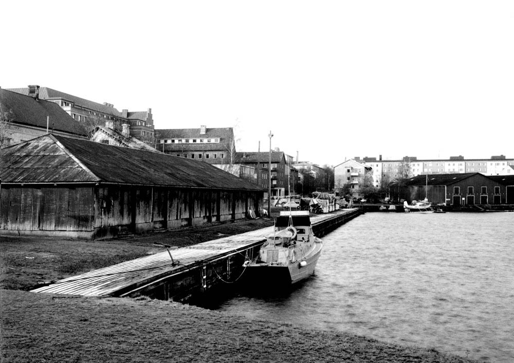 Vy över kaj med magasinsbyggnader av plåt.